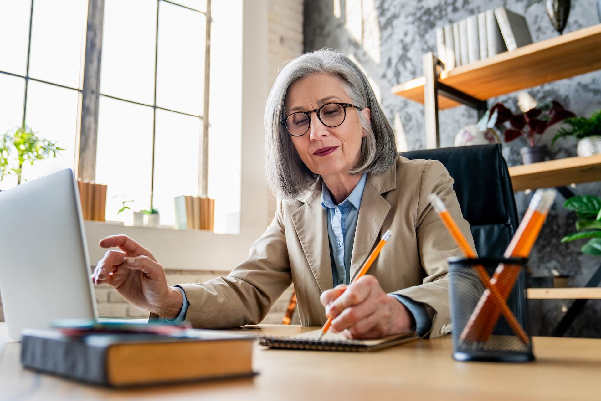 Professional in her 60s working at her office desk